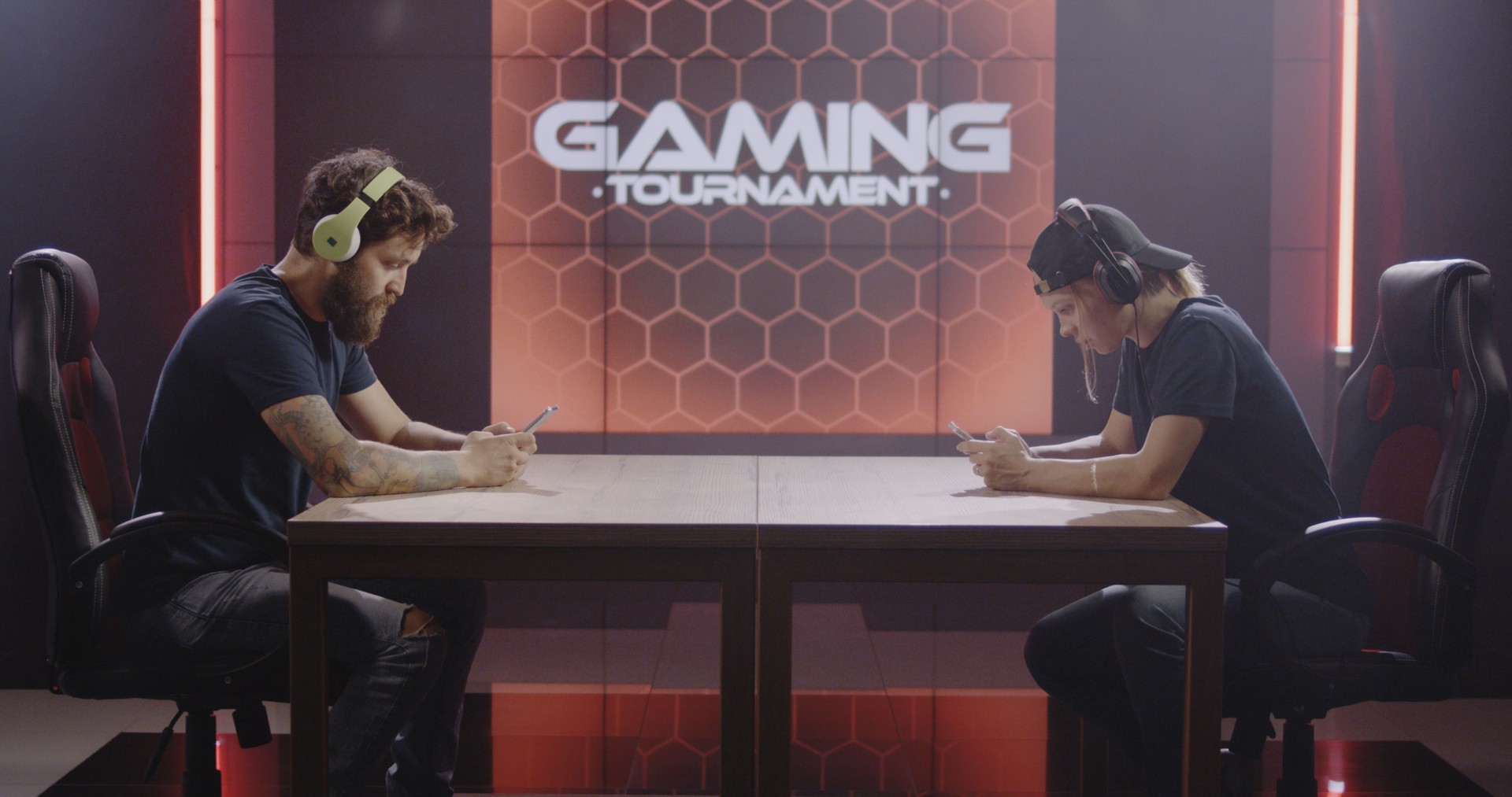 Man and woman competing at a mobile gaming tournament
